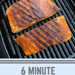 Two pieces of grilled salmon on a cast iron grill