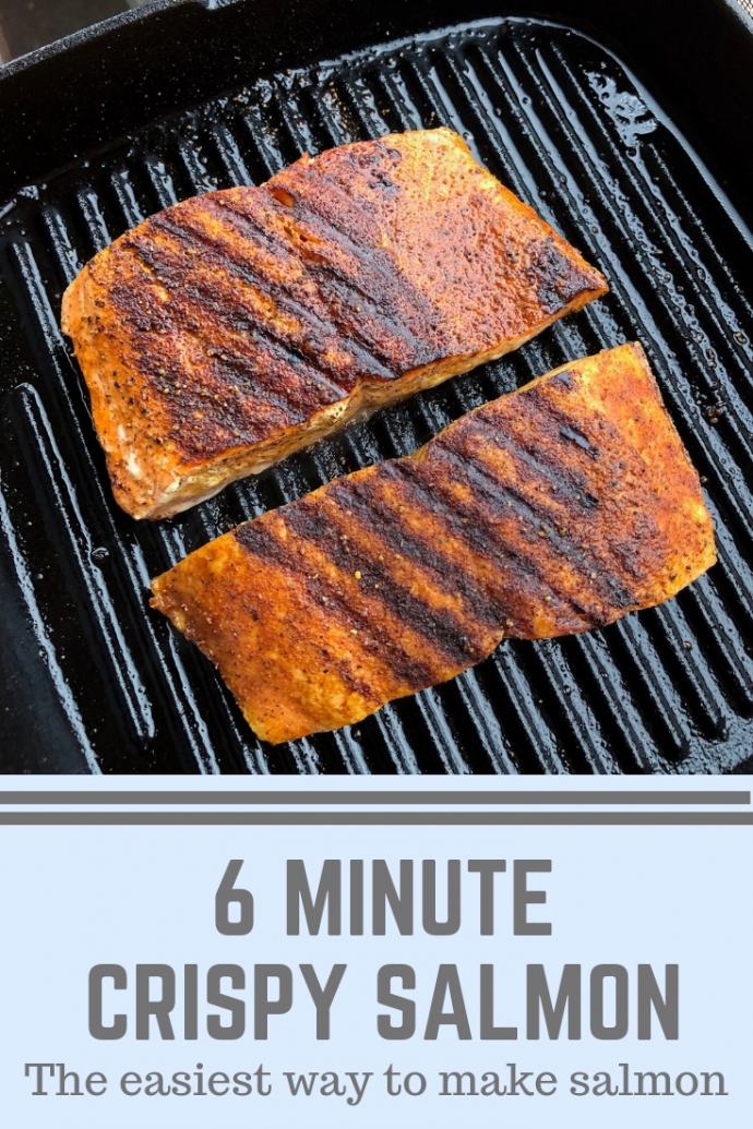 Two pieces of grilled salmon on a cast iron grill 