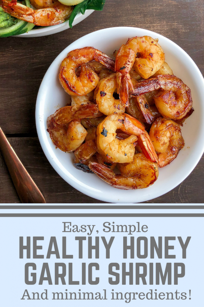 honey garlic shrimp in a white bowl on a wood background