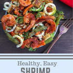 Shrimp with stir fry veggies and zucchini noodles on a wood background.