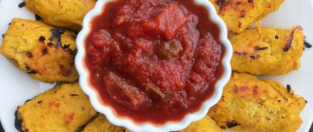 spaghetti squash tater tots on a white plate with salsa in a cup in the middle