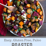 Roasted beet, brussels, sweet potatoes, feta salad in a white bowl on a brown board