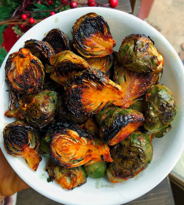 Spicy brussel sprouts in a white dish.