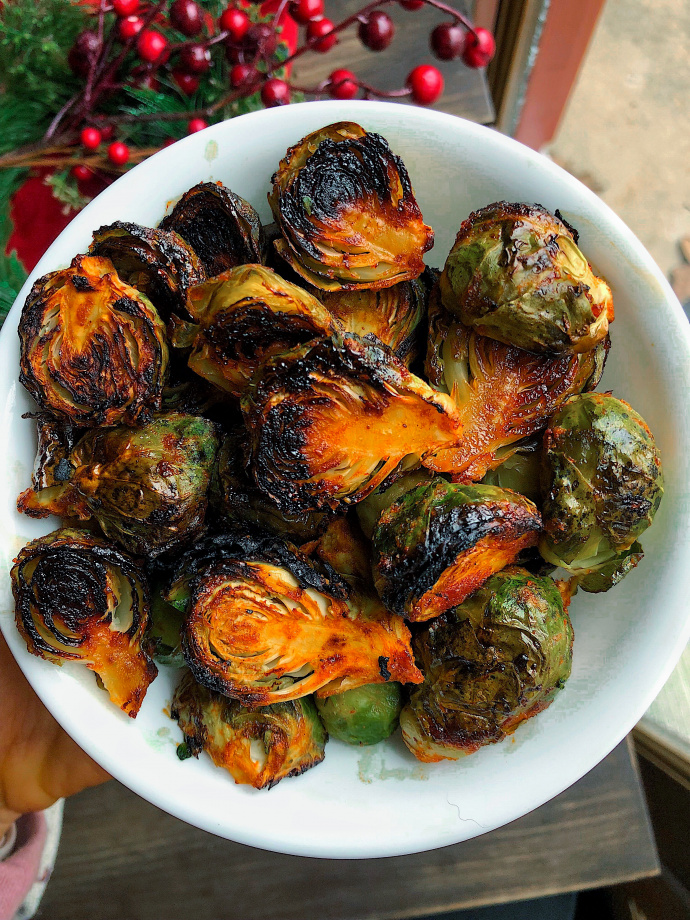 Spicy brussel sprouts in a white dish.