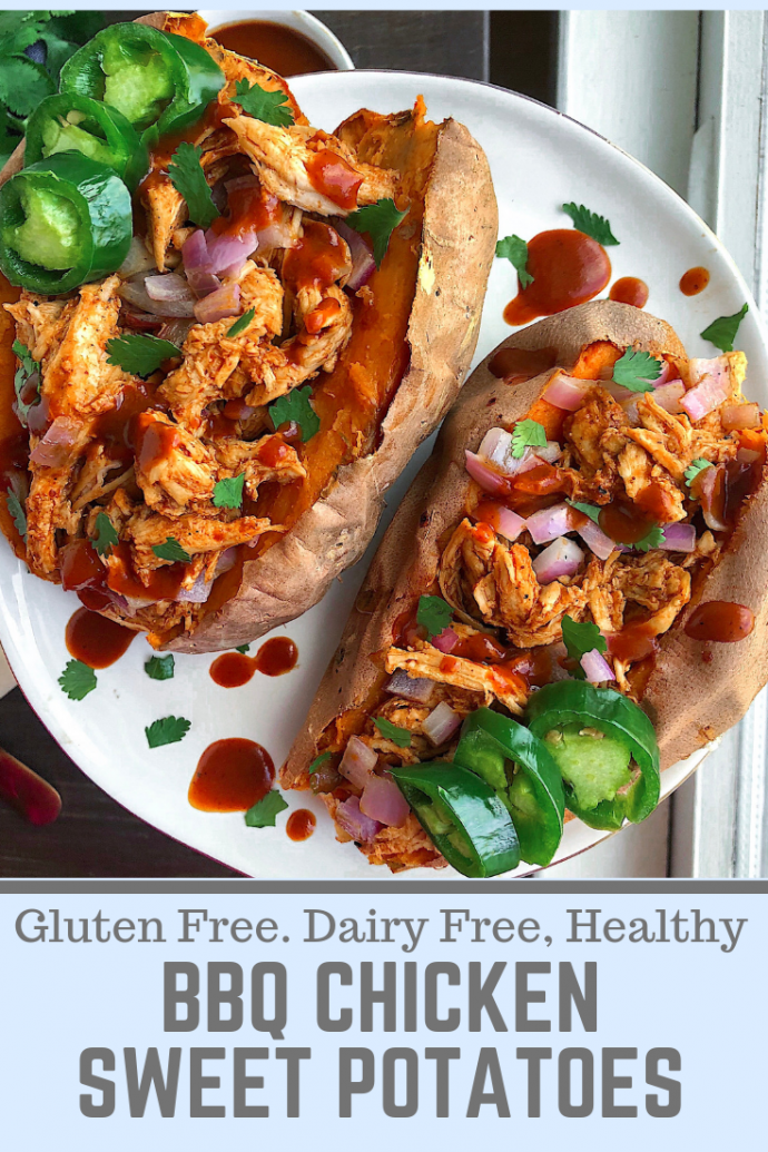 Two sweet potatoes stuffed with bbq chicken on a white plate