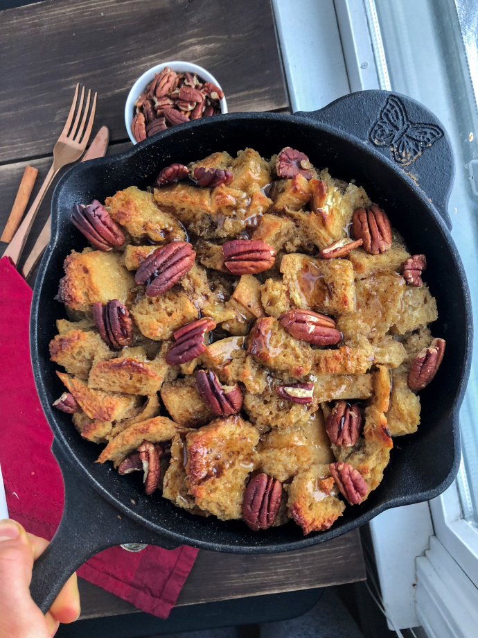 Maple Pecan French Toast bake on a white plate against a wood background