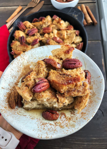 Maple Pecan French Toast bake on a white plate against a wood background