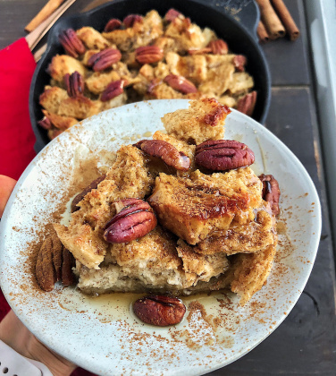 Maple Pecan French Toast bake on a white plate against a wood background