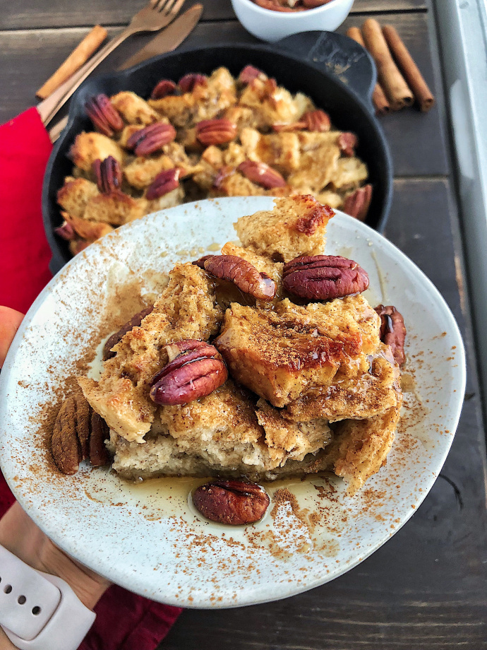 Maple Pecan French Toast bake on a white plate against a wood background