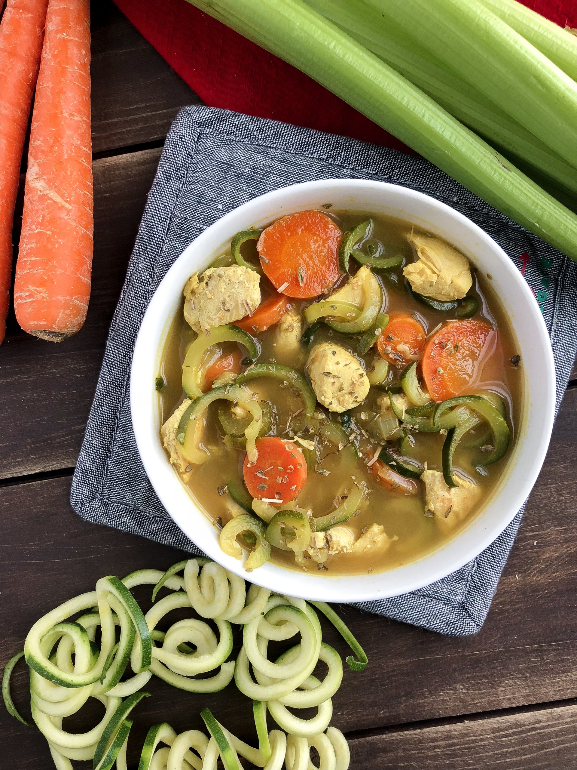 paleo chicken noodle soup on a wood background