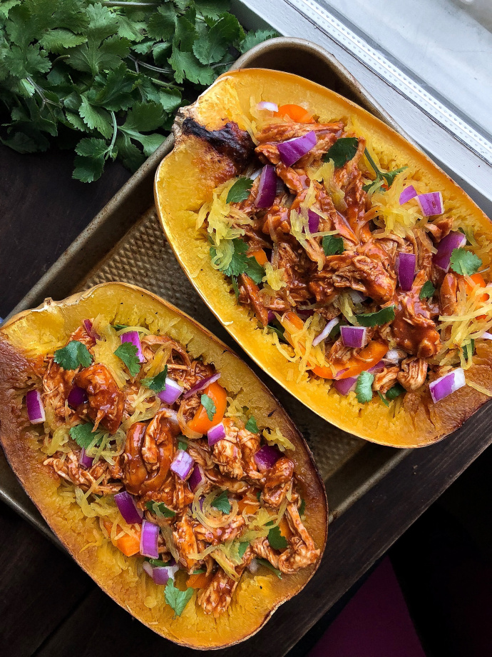 Paleo bbq chicken stuffed spaghetti squash on a silver pan