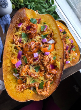 Paleo bbq chicken stuffed spaghetti squash on a silver pan