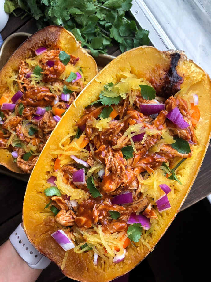 Paleo bbq chicken stuffed spaghetti squash on a silver pan