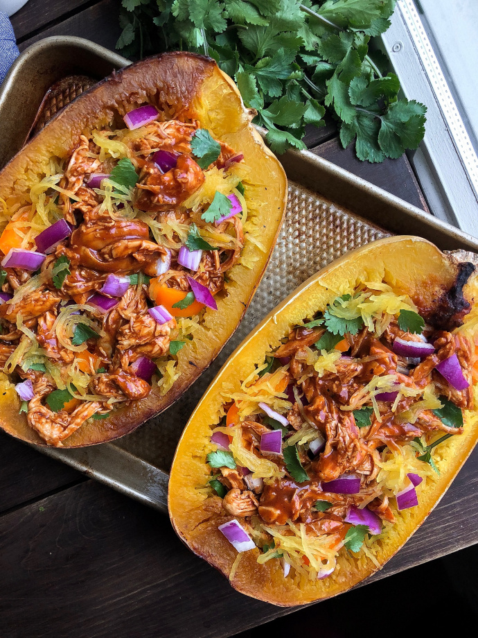 Paleo bbq chicken stuffed spaghetti squash on a silver pan 