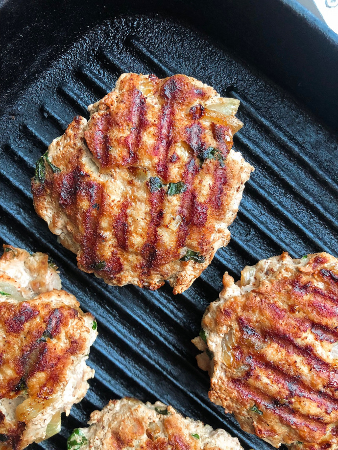 paleo turkey burgers on a black cast iron grill