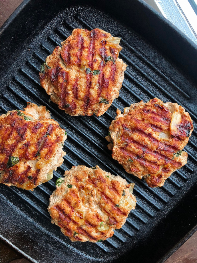 paleo turkey burgers on a black cast iron grill