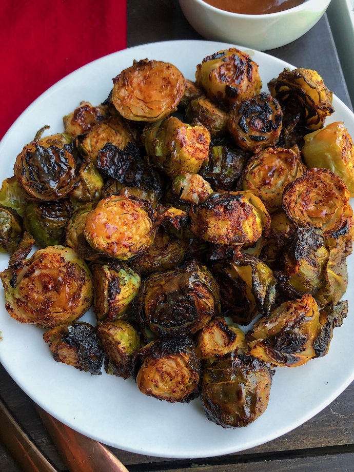 barbecue brussel sprouts on a white plate.