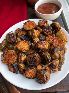 barbecue brussel sprouts on a white plate.