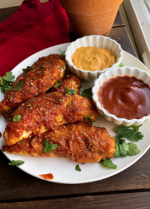 paleo bbq chicken tenders with cheese sauce and bbq sauce to dip