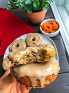 paleo pumpkin donuts on a white plate with a 3 ingredient icing