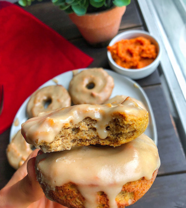 paleo pumpkin donuts on a white plate with a 3 ingredient icing