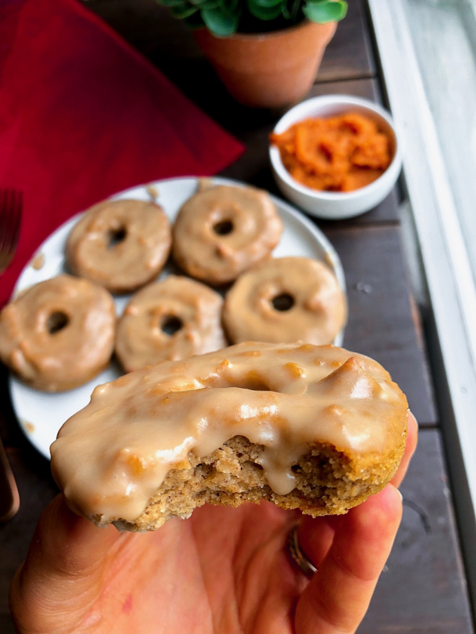 paleo pumpkin donuts on a white plate with a 3 ingredient icing