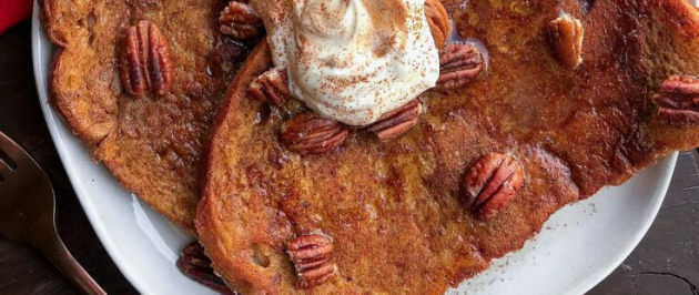 vegan maple pumpkin french toast on a white plate with pecans