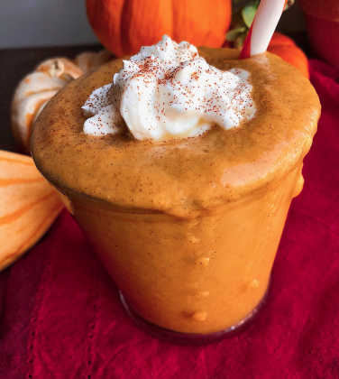 healthy pumpkin pie smoothie in a glass jar with a vegan yogurt on top.