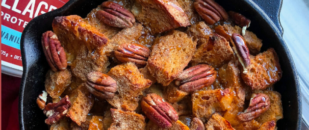 french toast bake in a cast iron skillet with pumpkin and pecans