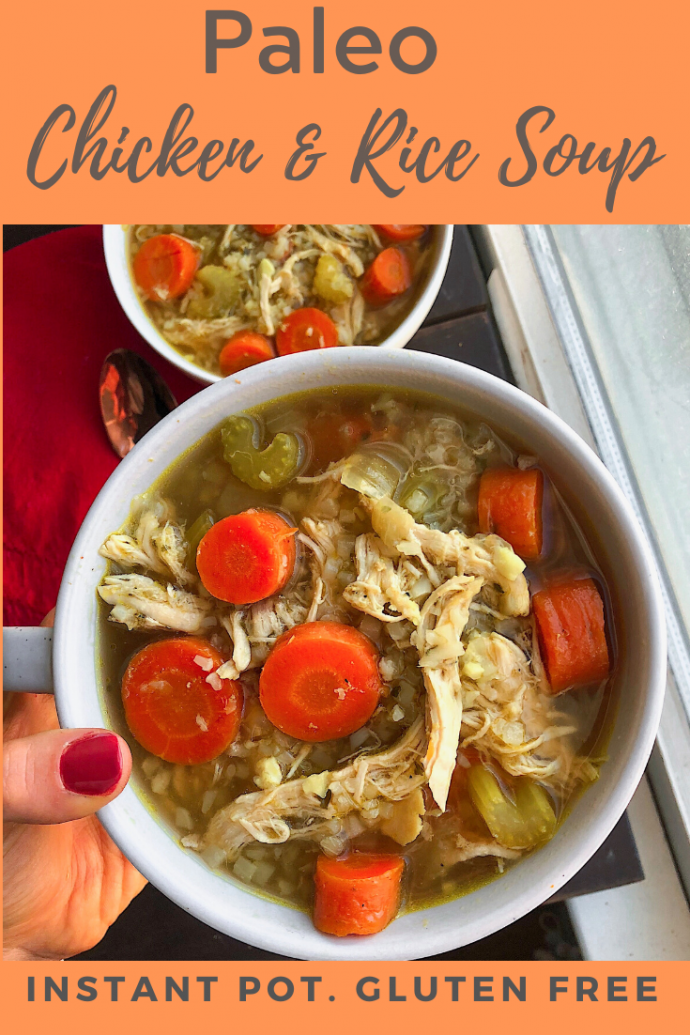 healthy chicken and rice soup with cauliflower rice and carrots in a white bowl