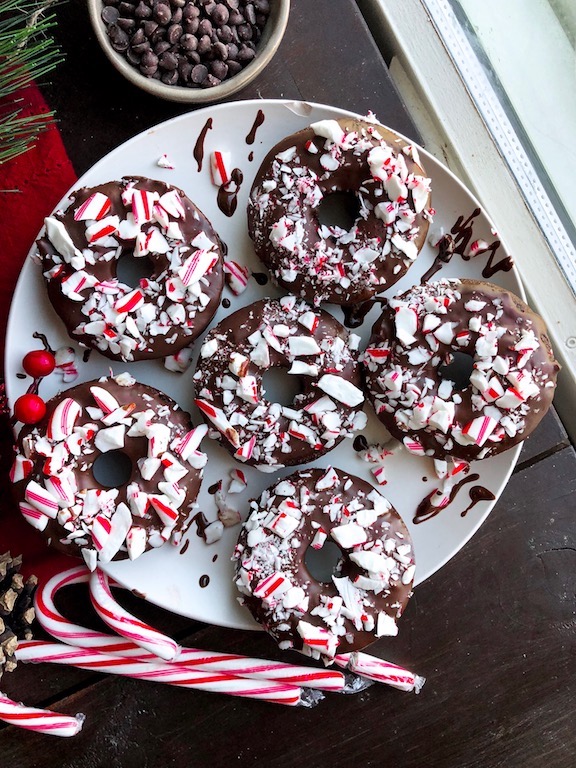 peppermint chocolate donuts with crushed candy canes on top 