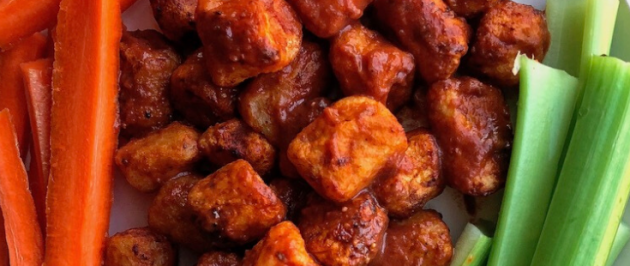 air fried bbq cauliflower on a white plate with carrots and celery