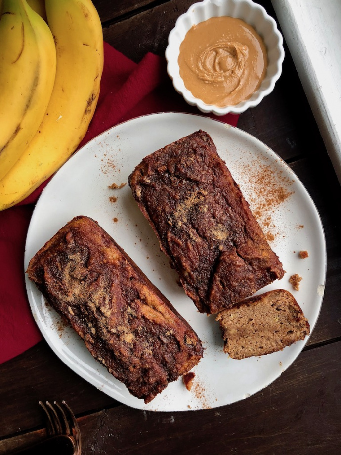 cinnamon banana bread with a cinnamon swirl on a white plate