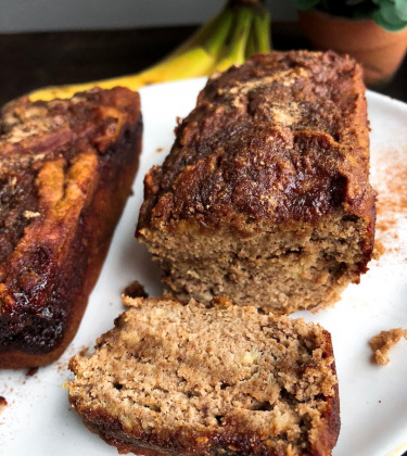 cinnamon banana bread with a cinnamon swirl on a white plate