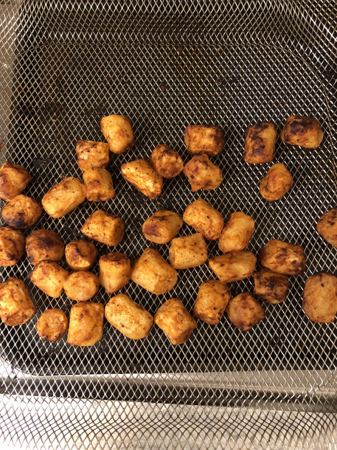 air fried bbq cauliflower on a white plate with carrots and celery