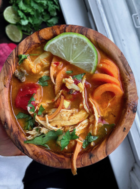 Coconut Curry Chicken Soup in a wooden bowl. Paleo, Gluten free, whole30