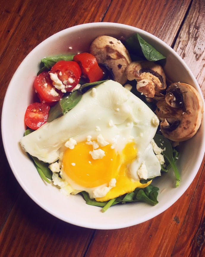 egg in a bowl with mushrooms and tomatoes