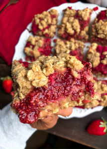 strawberry crumble bars on a white plate